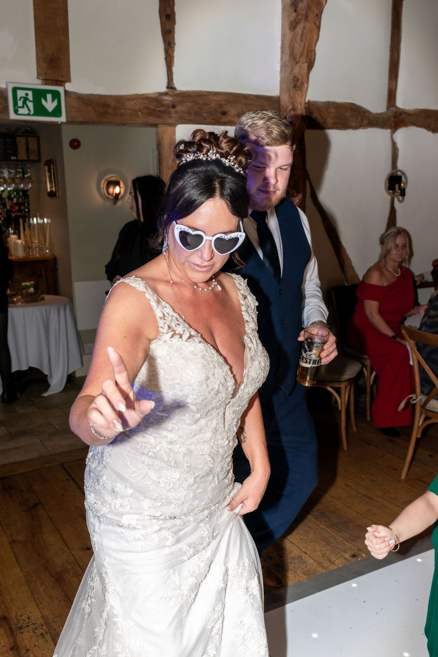 Wedding reception celebration with dancing and entertainment in a rustic barn venue.