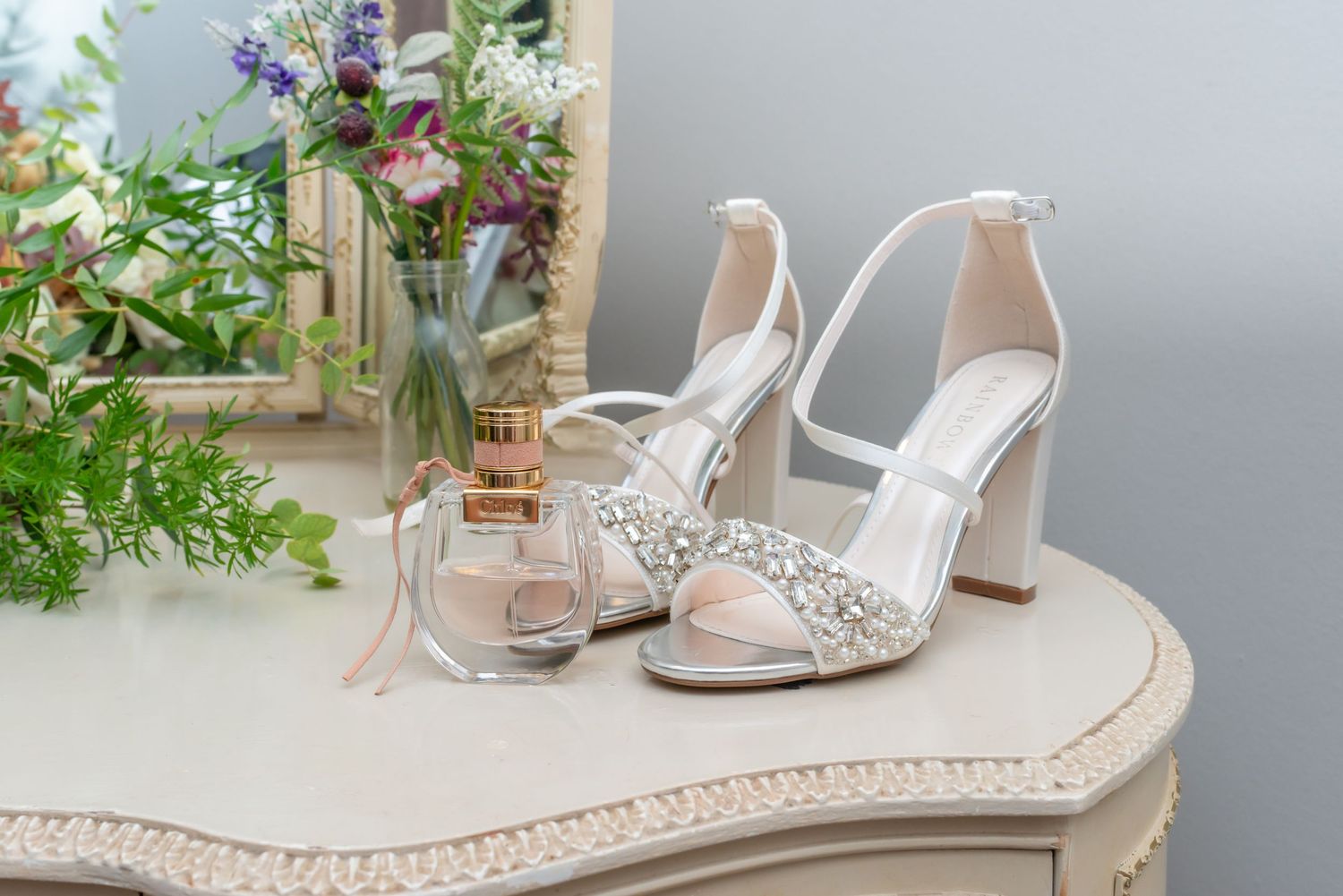 Elegant white crystal bridal sandals and block heels with floral wedding details; professional wedding day photography by Michael Pardoe
