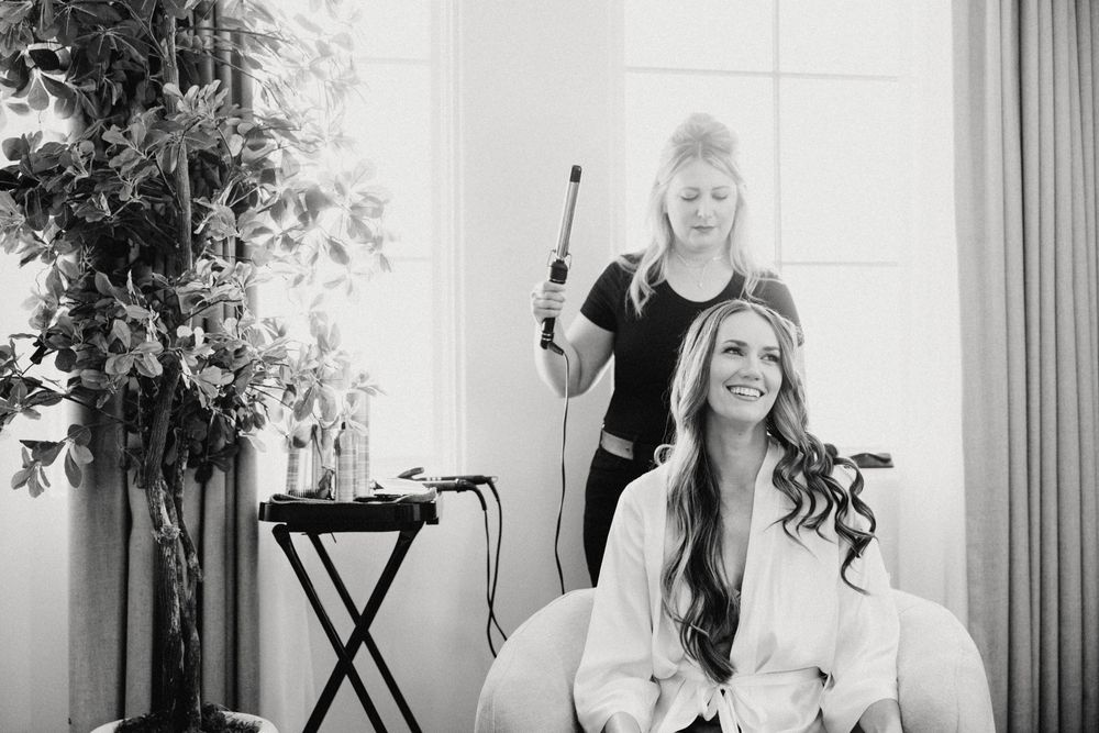 Black and white getting ready photos in a bright room.