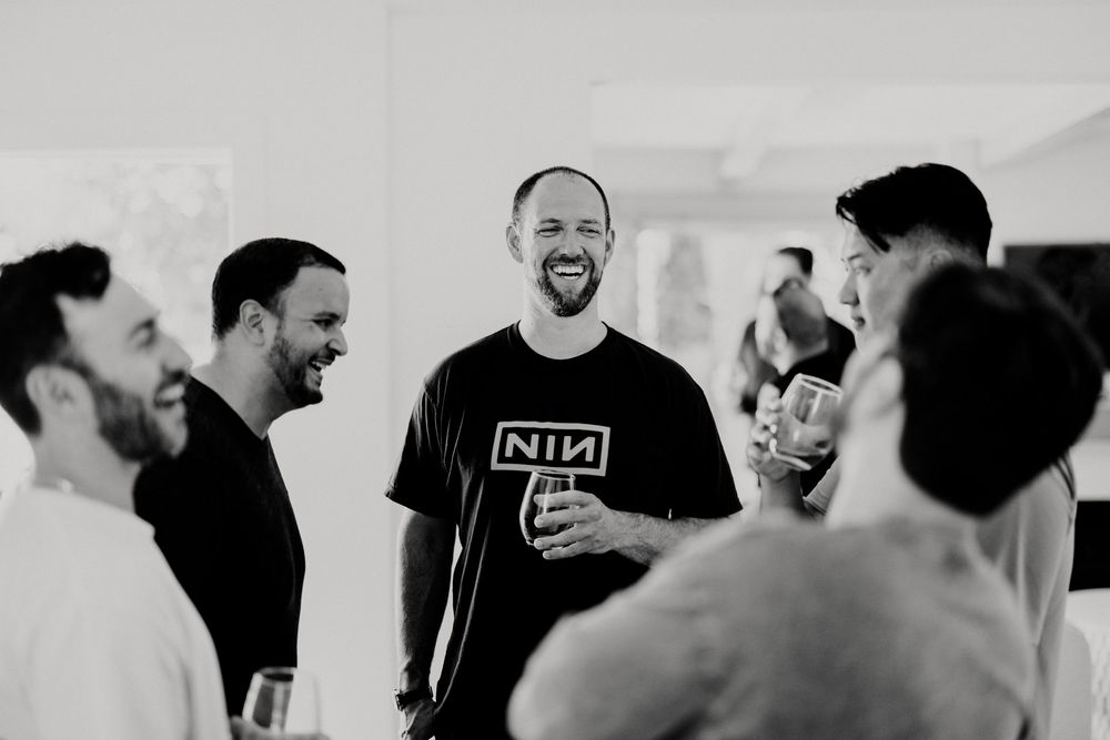 Groomsmen sharing laughs and conversations during wedding preparations.