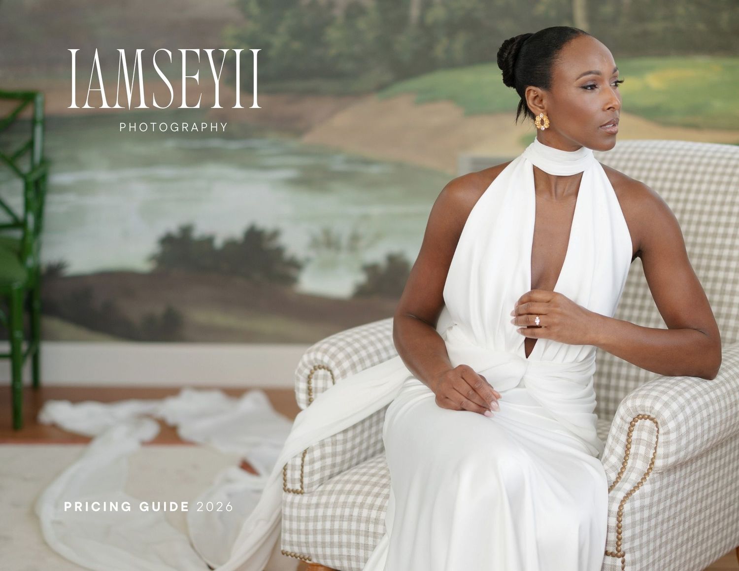 Elegant white halter wedding gown with plunging neckline shown on model seated in luxurious outdoor setting.