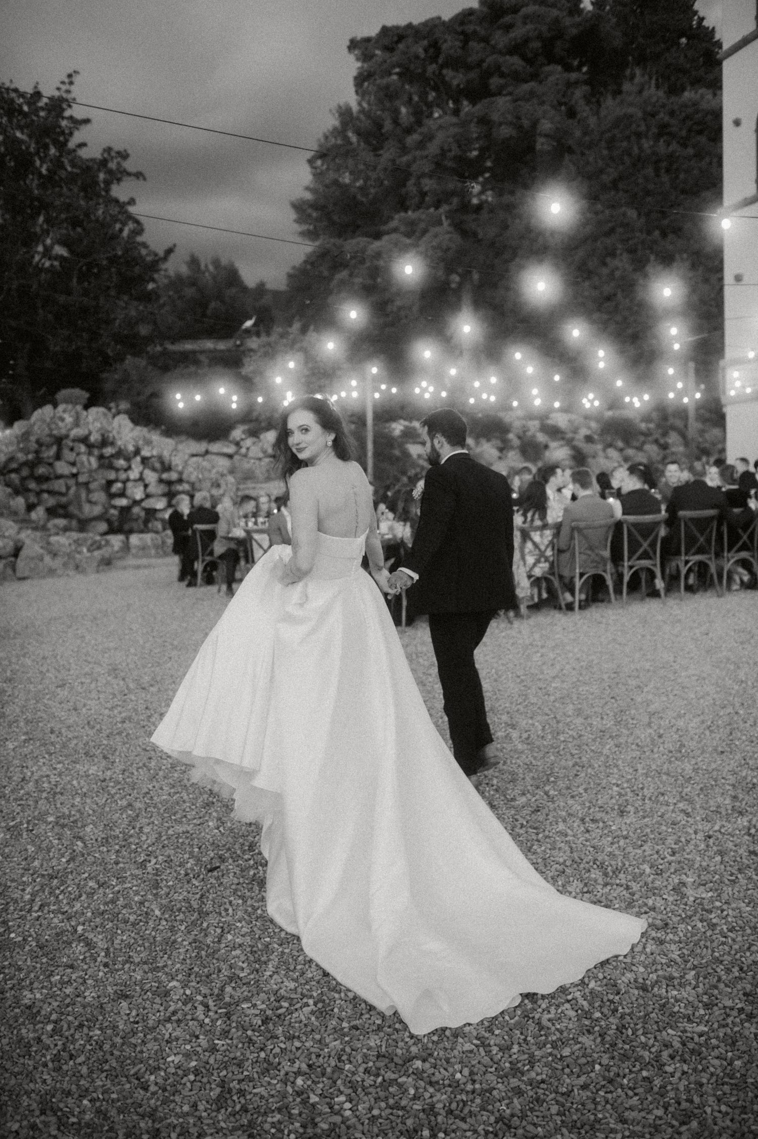 Elegant outdoor wedding reception with string lights creating a romantic ambiance.
