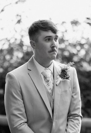 Black and white wedding photo sequence showing groom's emotional reaction during first look moment.