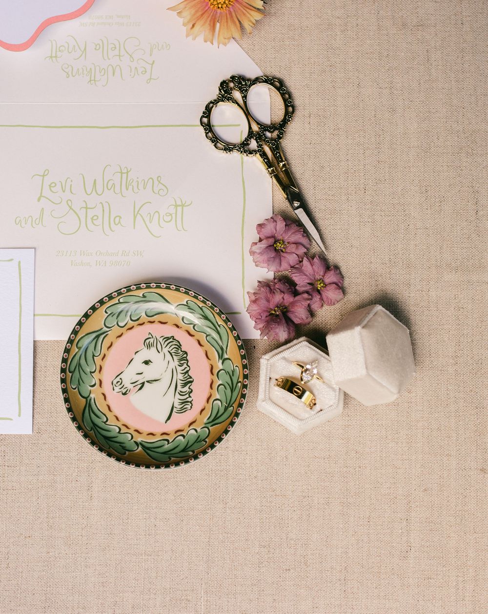 Vintage ornate decorative frames and scissors arranged artistically on a neutral linen background.