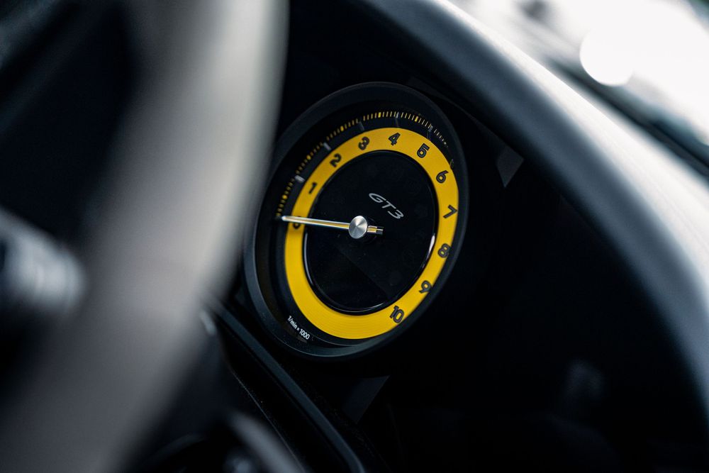 Series of yellow racing gauges and instrument displays in a performance vehicle dashboard.
