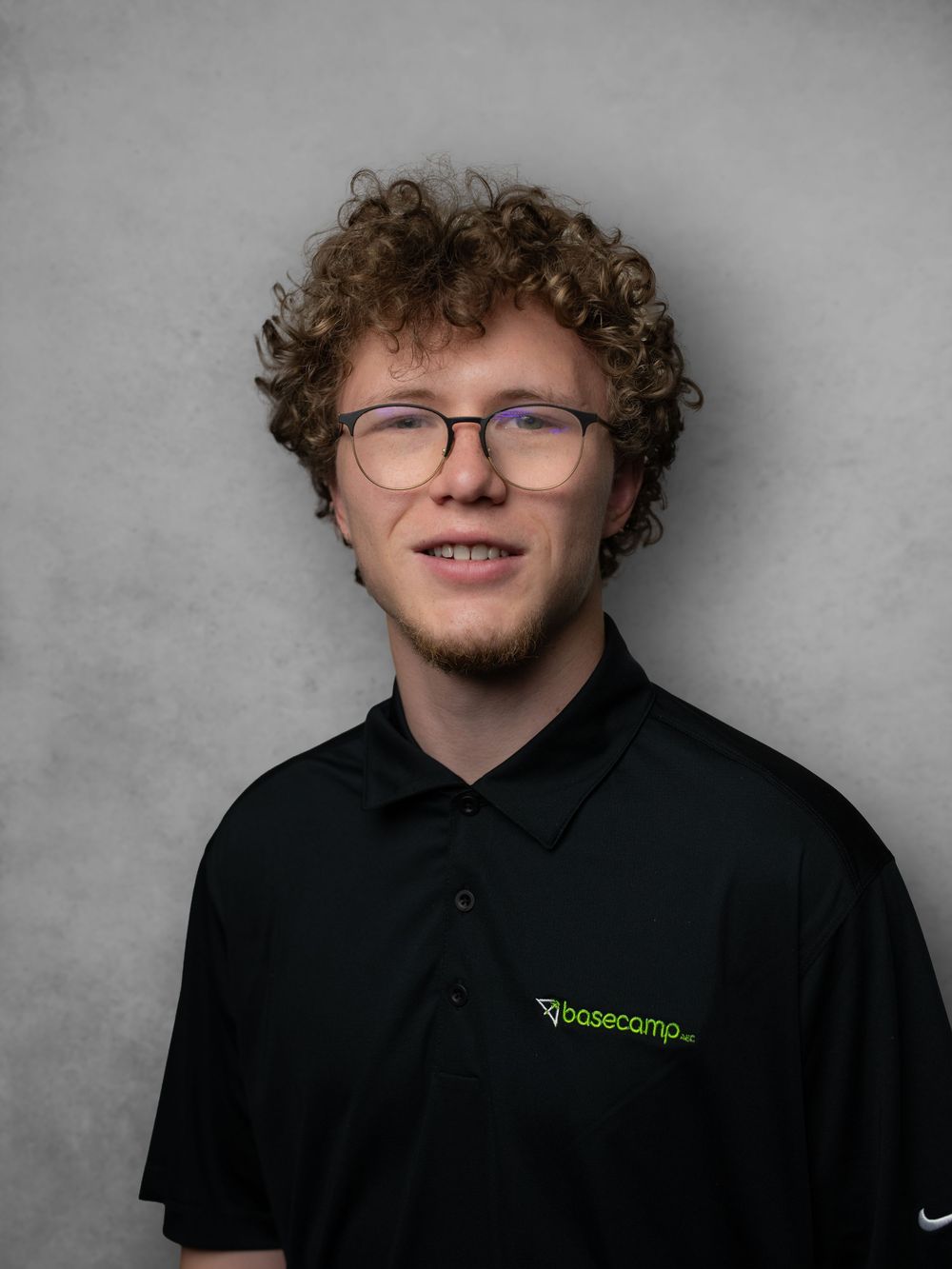 Series of portraits showing someone in glasses wearing a black polo shirt against a gray backdrop.