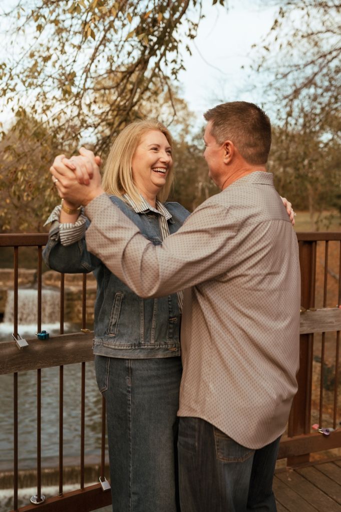 Candid moments of laughter and joy shared between people on a lakeside deck during golden hour.