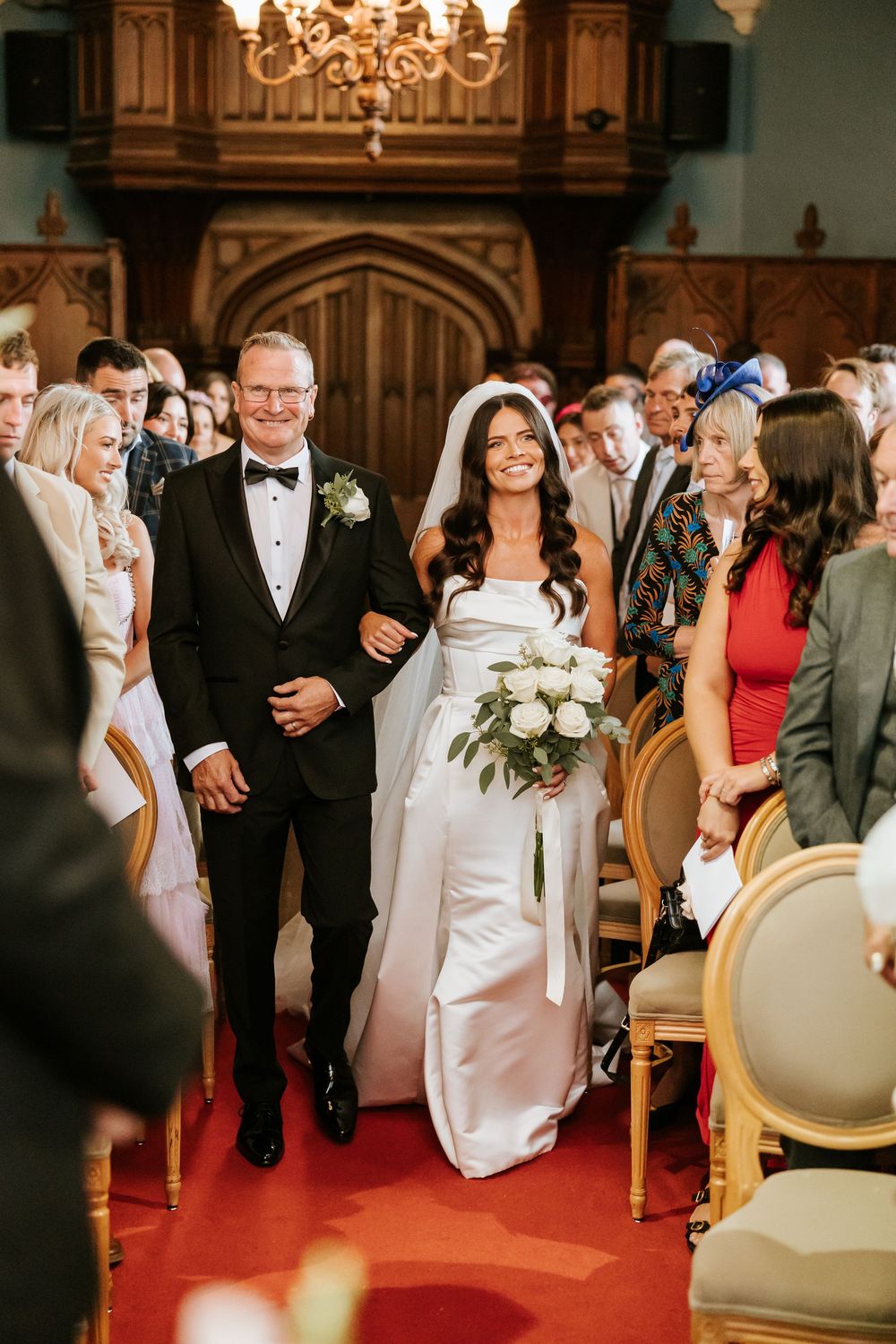 Bride walking down the aisle with her father in a elegant church wedding ceremony, wearing a white gown. Markree Castle Sligo