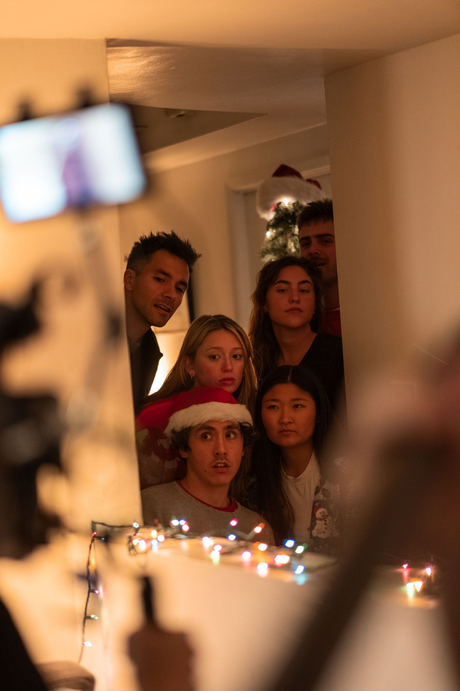 Group of people illuminated by soft candlelight during an intimate gathering.