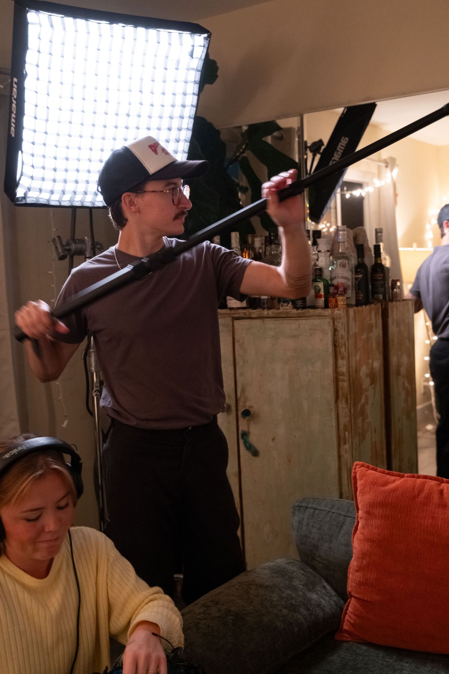 Behind the scenes photo shoot setup with lighting equipment and crew.