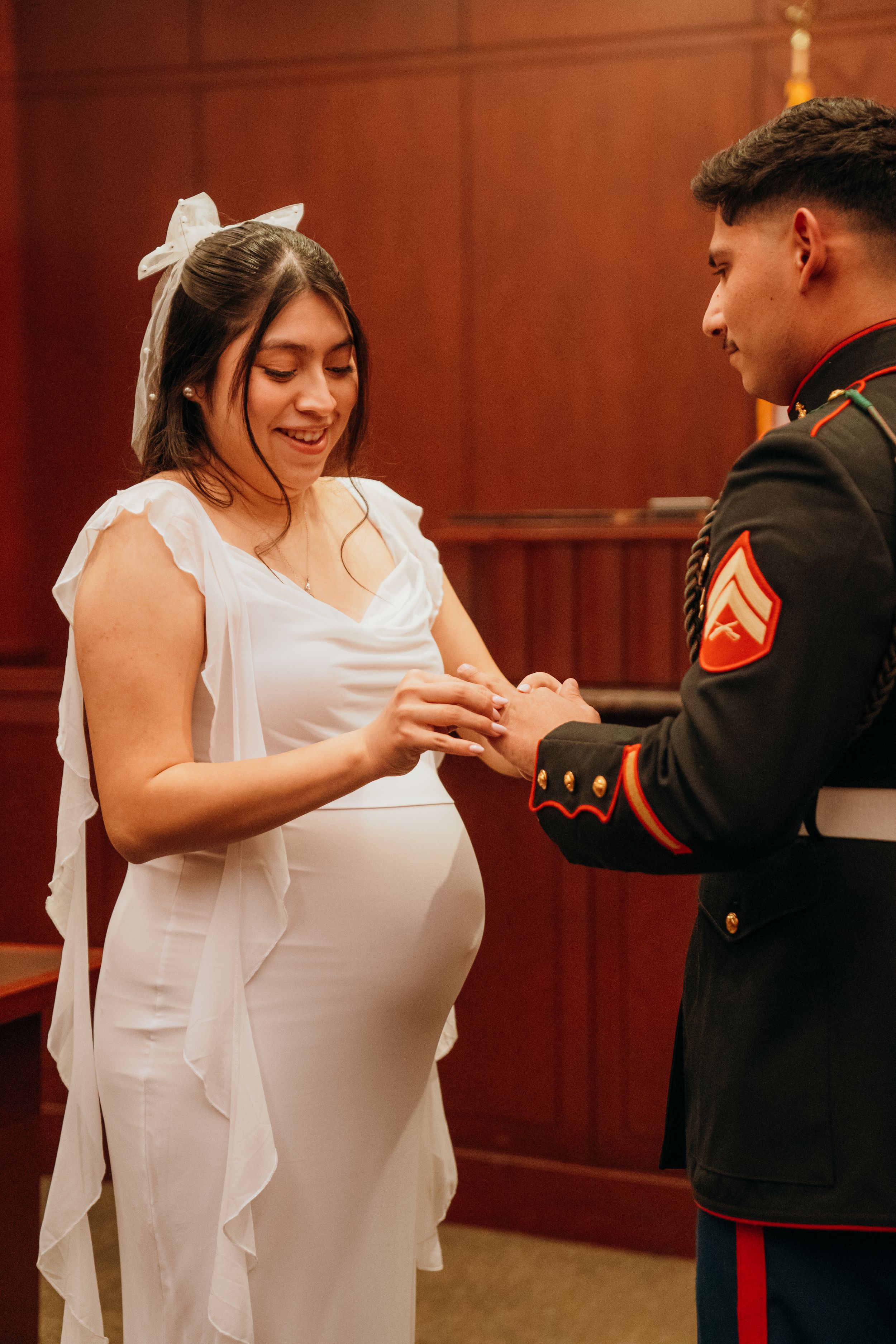 A couple shares an intimate dance moment in formal attire at a courthouse wedding ceremony.