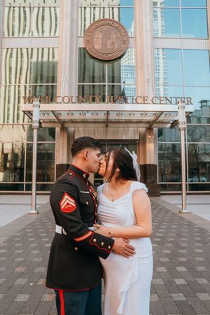 A couple shares a romantic moment outside the Columbus Justice Center building.