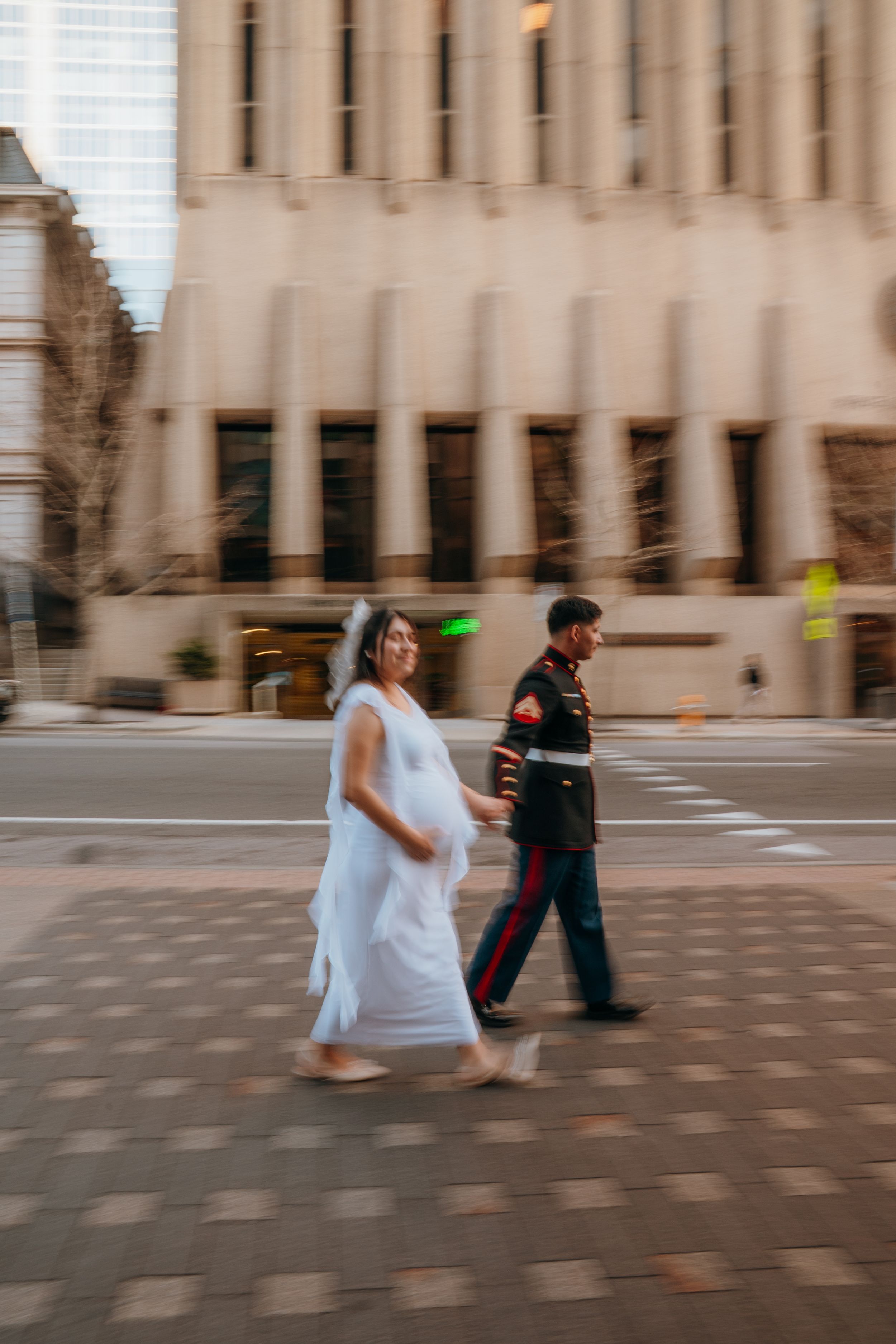Motion-blurred sequence shows newlyweds dancing outside a government building after their ceremony.