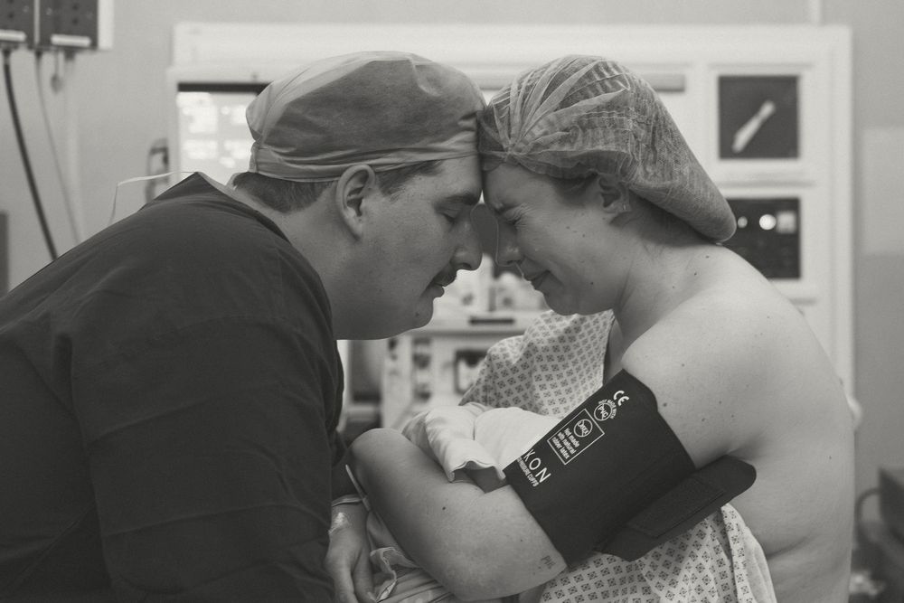 Two people embrace in a tender moment while dancing together at what appears to be a social dance event.