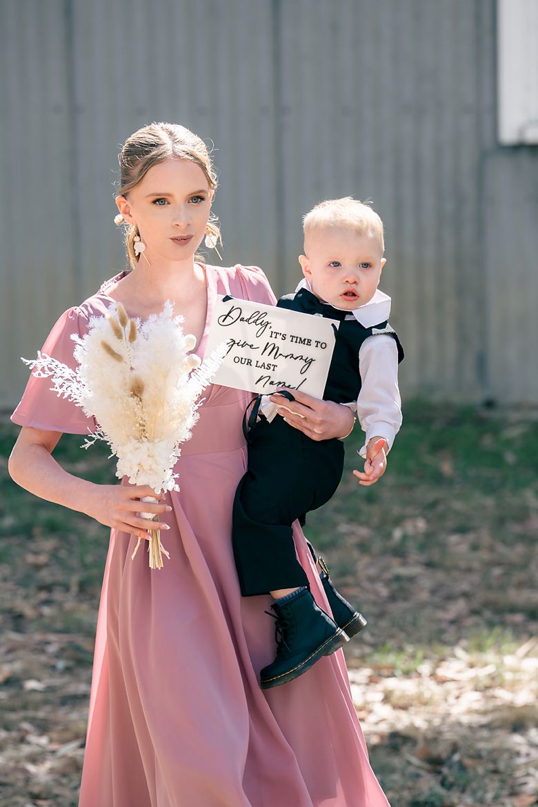 A series of four photos showing a mother in a pink dress holding a small child in formal attire outdoors.
