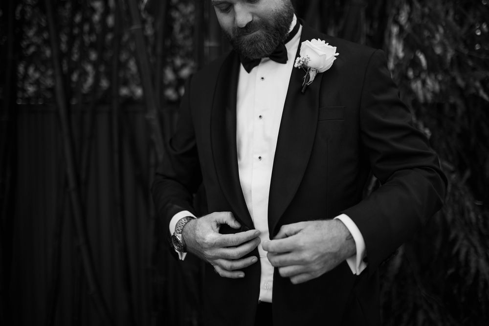 Elegant black and white photos of formal attire details at a black tie event.