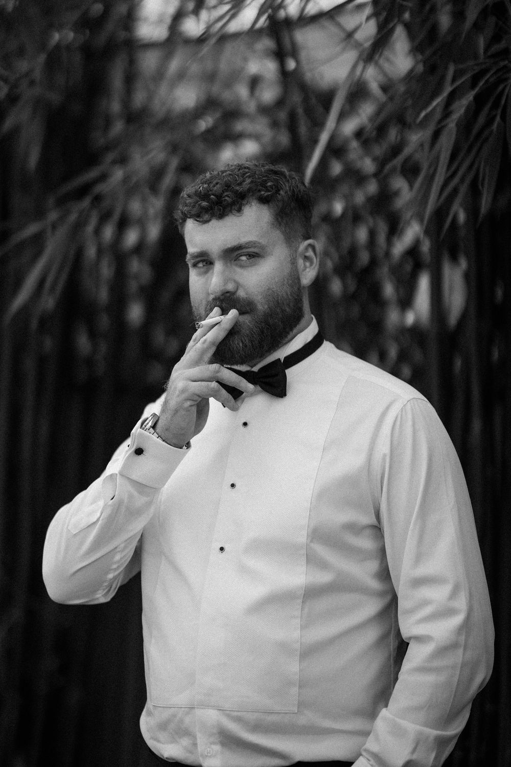 Black and white emotional moment captured during wedding preparations.