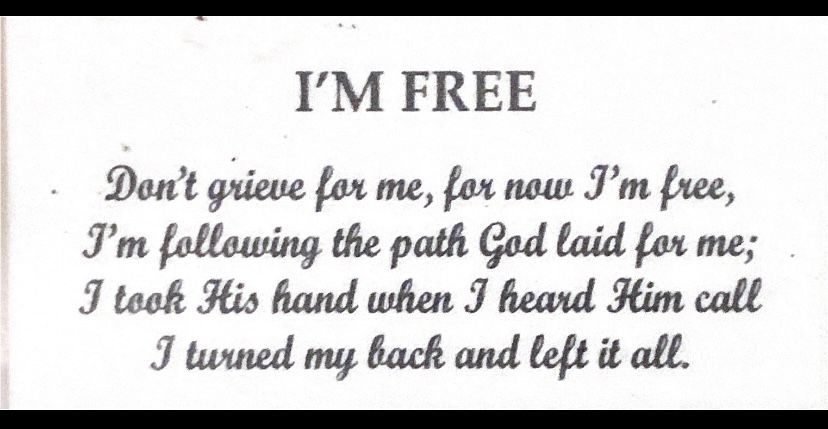 A handwritten poem titled 'I'm Free' with multiple verses written in black ink on white paper.