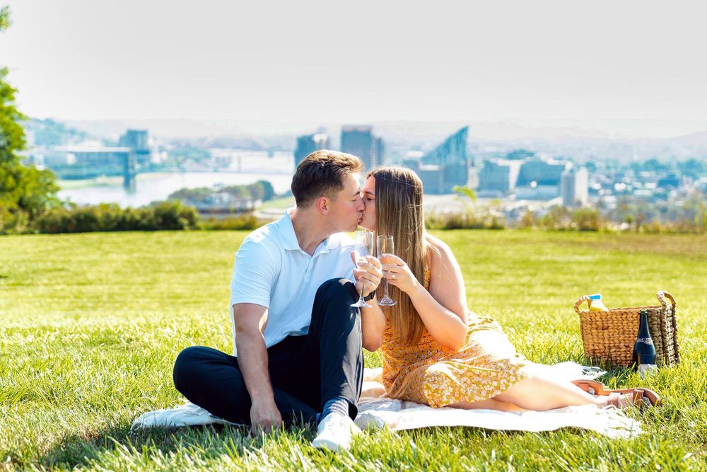 Max proposing to Morgan at Devou Park with champagne and a picnic at Drees Pavillion:Cincinnati wedding photographer engagement photographer