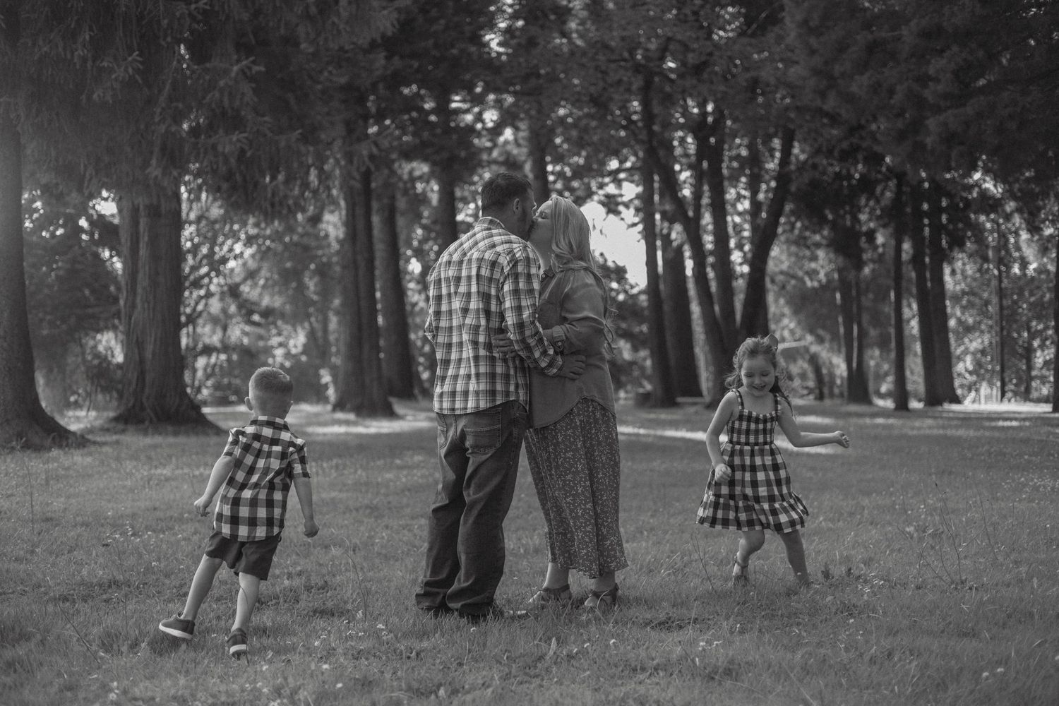 A sequence of black and white photographs showing people walking together through a tree-lined park path.