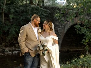 Couple embracing in a romantic garden setting during a wedding photo session.