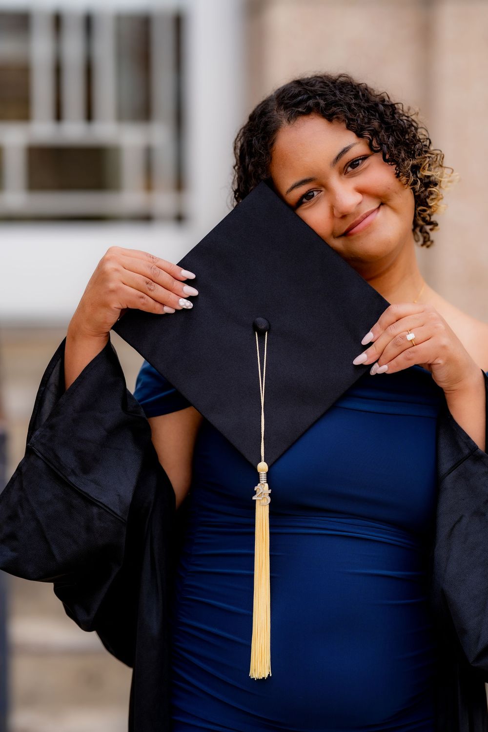 A series of graduation photos showing someone in a blue dress posing with a gold tassel against a light background.