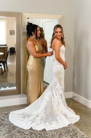 Elegant lace wedding dress with long train shown from multiple angles in a bridal fitting room.