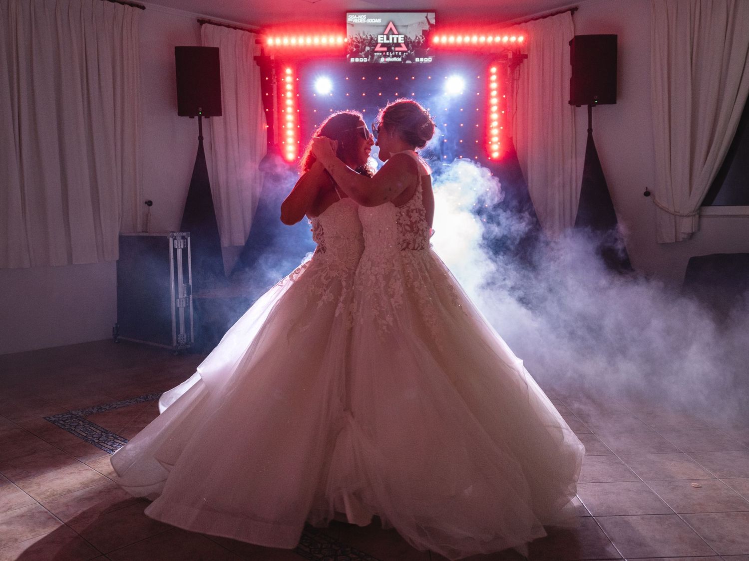 Wedding dance floor with red LED lights and fog effects creating dramatic atmosphere.