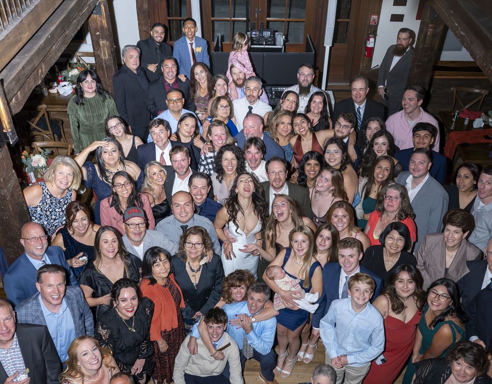 Large group photo of people gathered indoors for what appears to be a social or professional event.