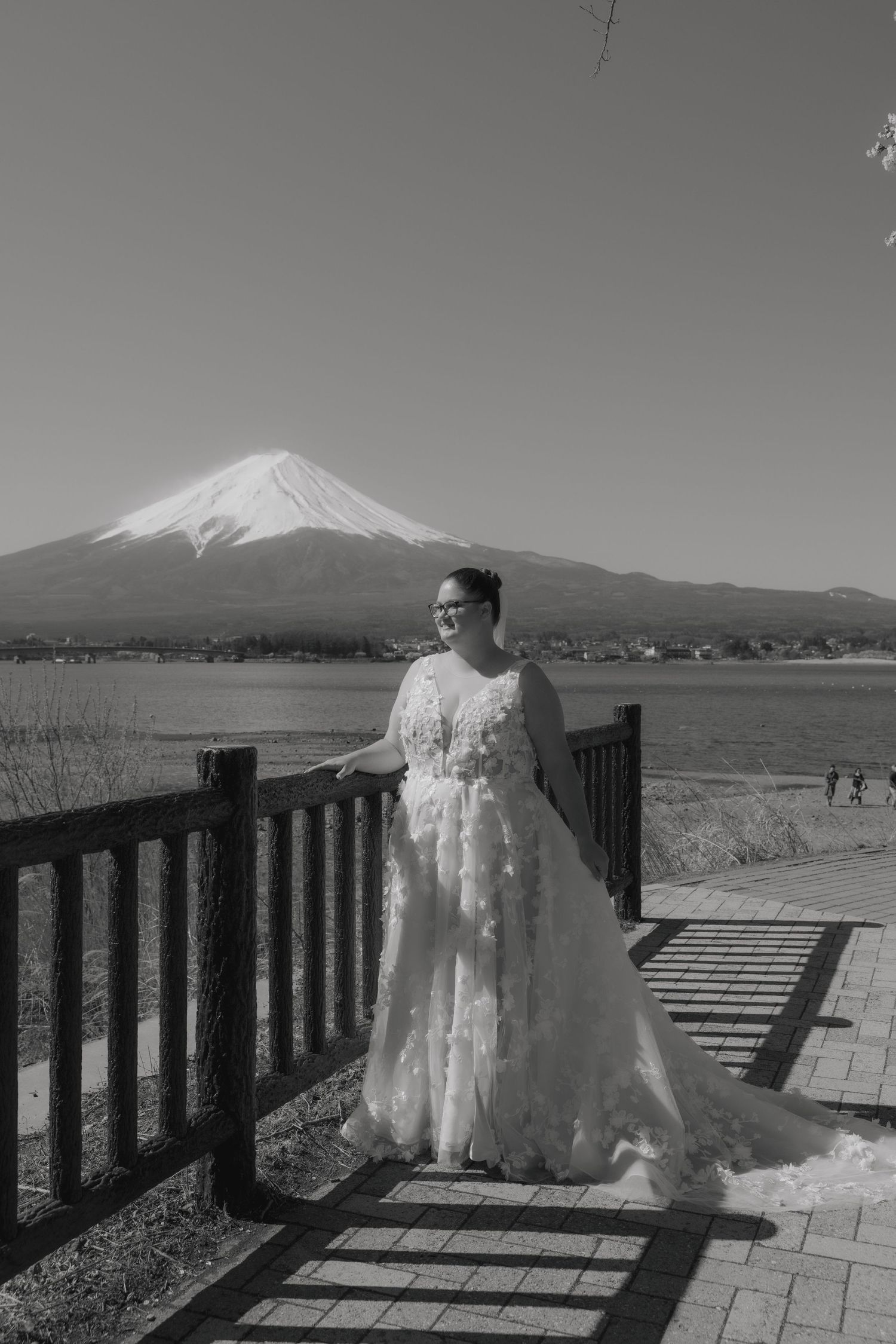 A sequence of black and white photos showing Mount Fuji in Japan with a snowy peak and wooden railing in the foreground.