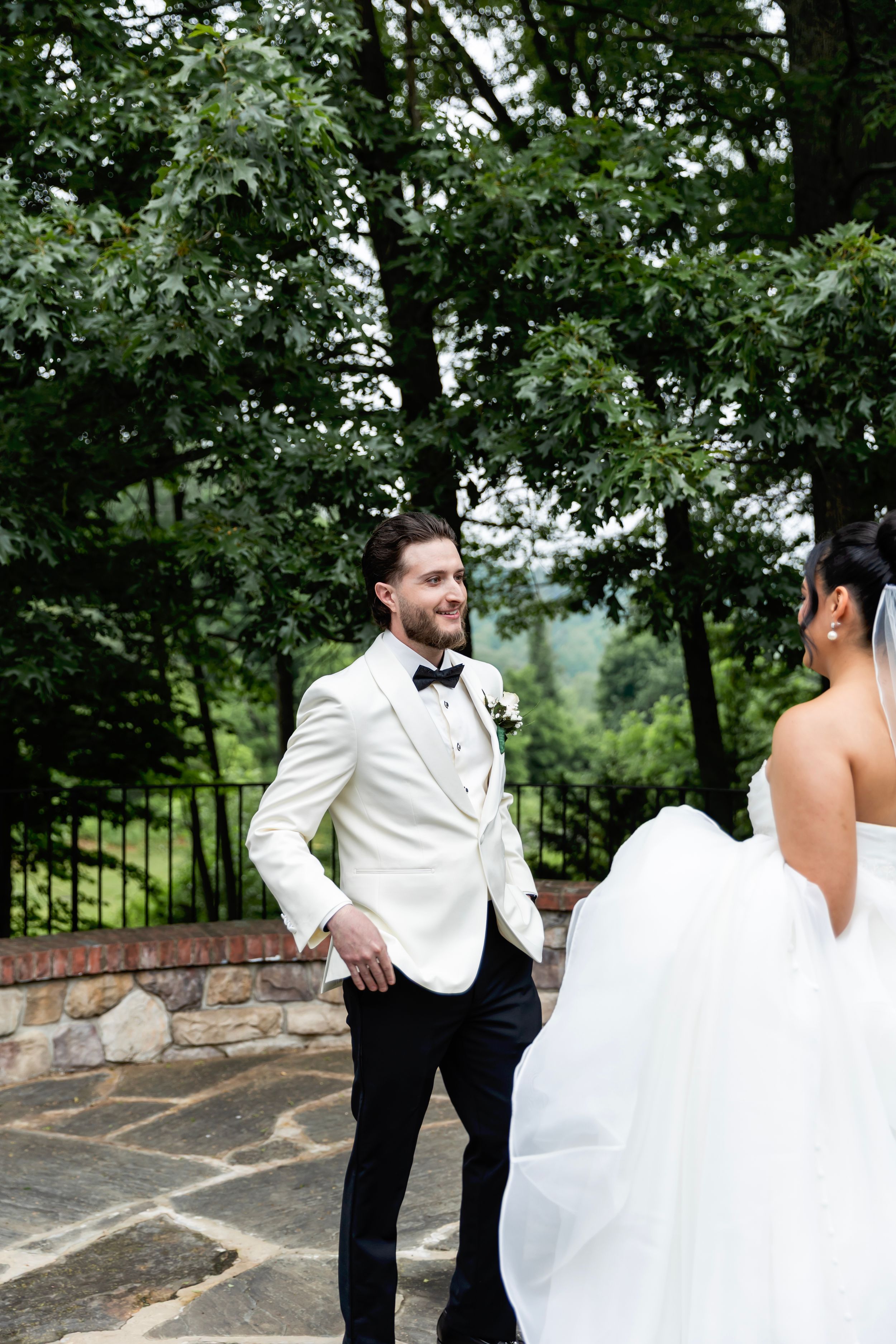 A couple shares their first look moment at an outdoor wedding venue - Sussex County wedding photographer