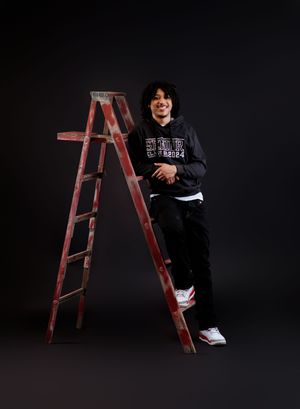 Artistic portrait series featuring poses with a vintage red ladder against a dark background.