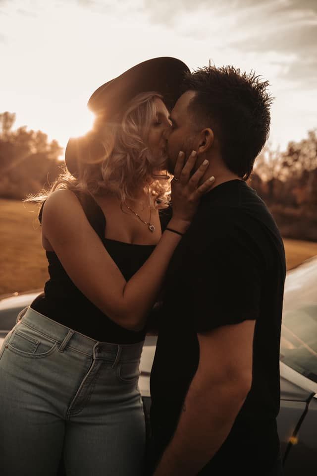 A passionate sunset kiss captured against a warm golden backdrop.