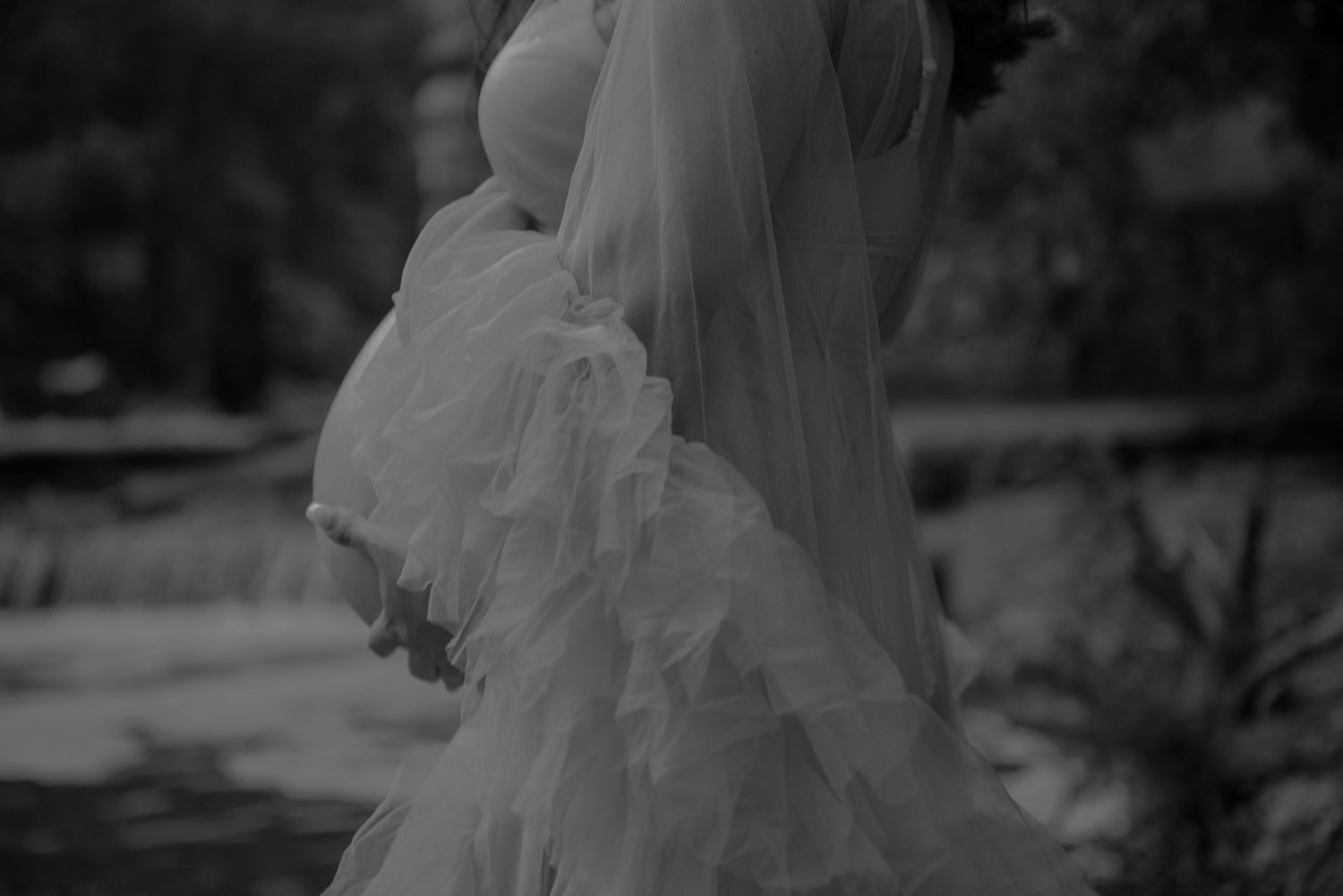 Close-up detail of a flowing white wedding dress veil in black and white.