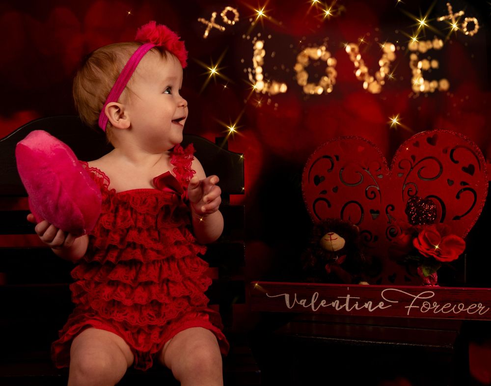 A romantic Valentine's Day themed photo collage with red hearts and sparkles against a dark background.