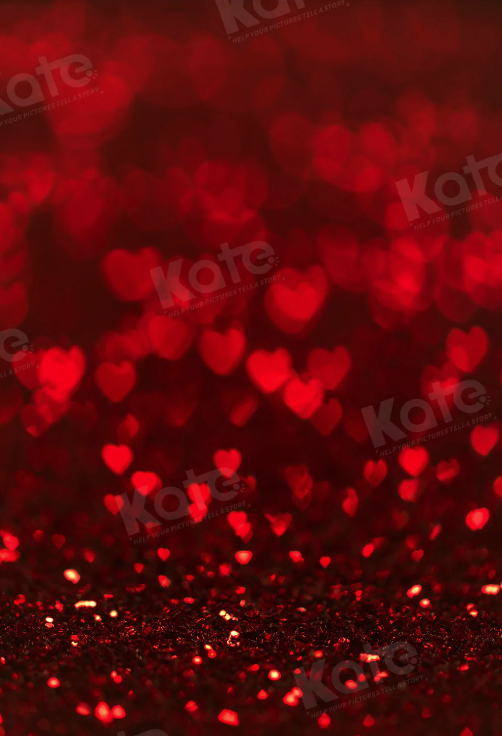 Red glowing heart-shaped bokeh lights scattered on dark background create romantic Valentine's Day atmosphere.