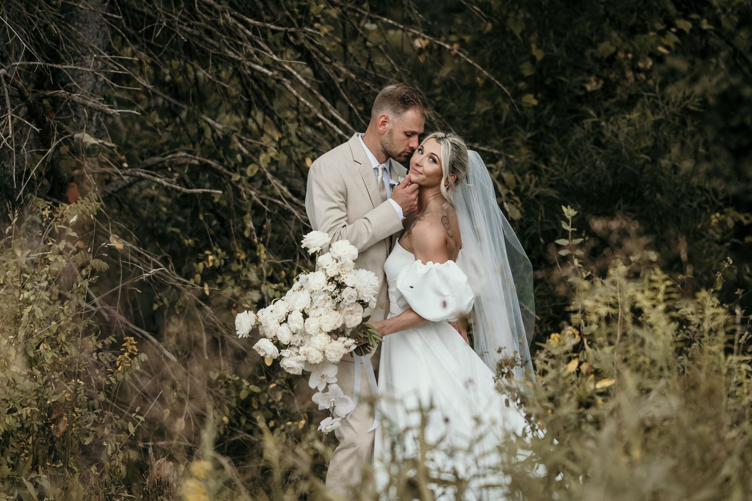 A romantic wedding couple shares intimate kisses in a series of outdoor portrait photos in soft natural lighting.