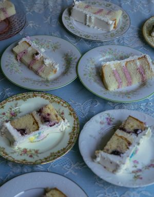 Slices of layered wedding cake served on delicate floral china plates.