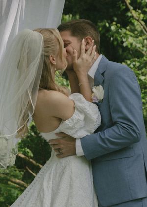 Romantic sequence of newlyweds sharing their first kiss under an outdoor wedding arch.
