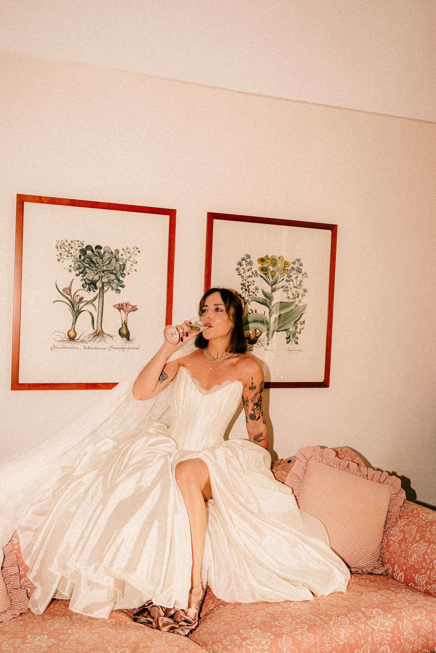 A figure in a white wedding dress poses against stone walls in a series of vintage-style photographs at night.