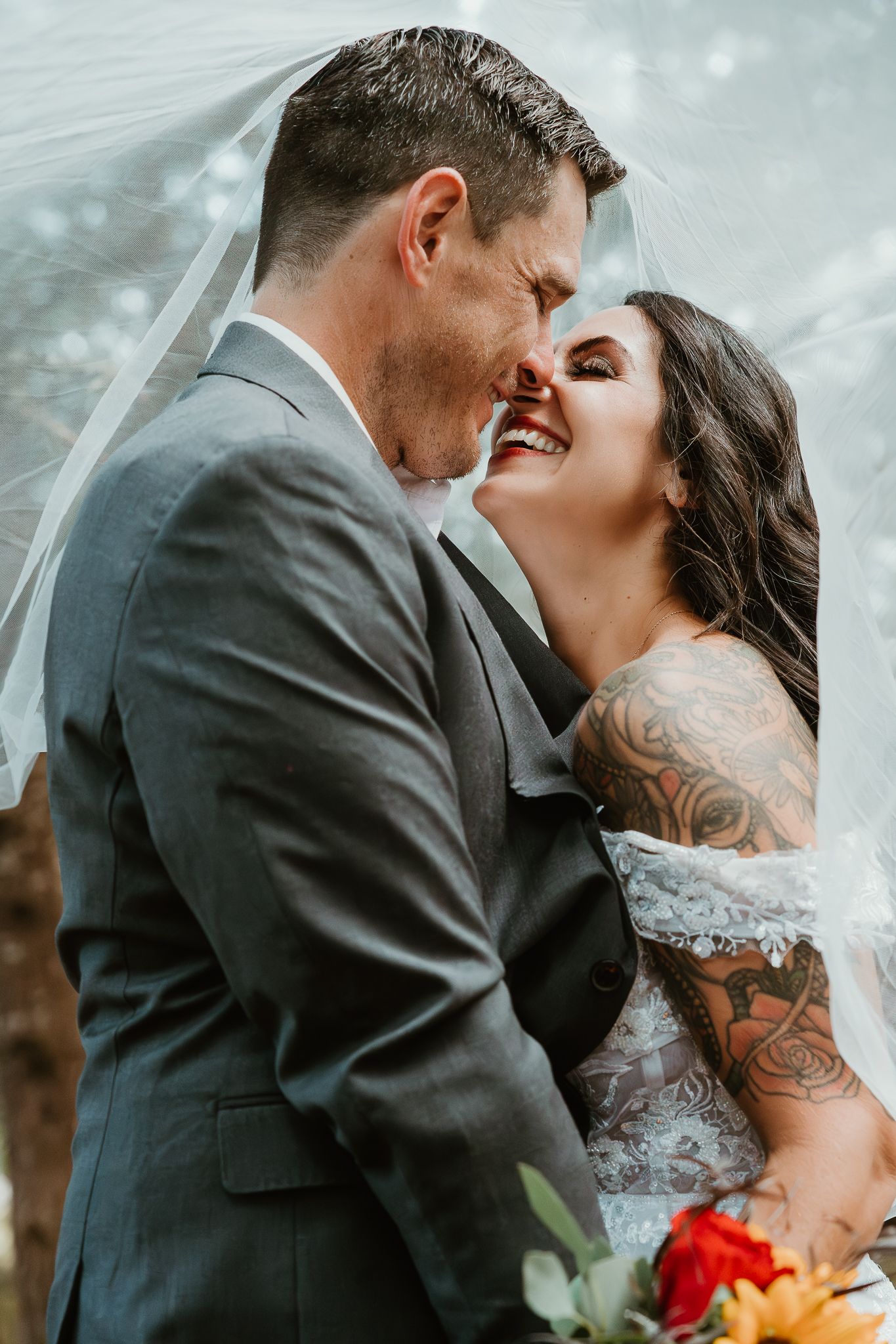 Smiling with teeth under the veil.