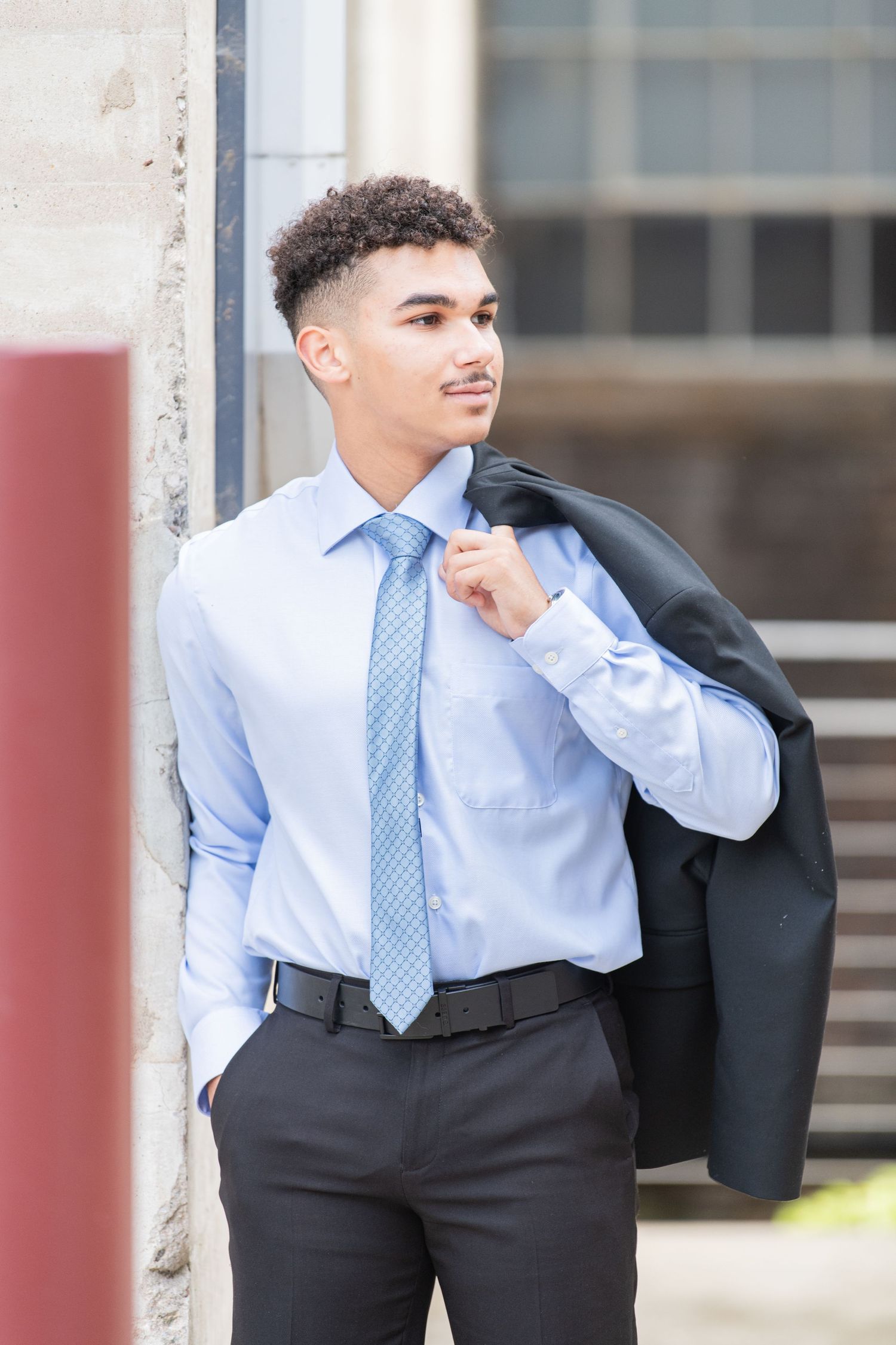 A senior boy looking elegant in his formal attire, captured in a stylish outdoor photo session, perfect for timeless memories!