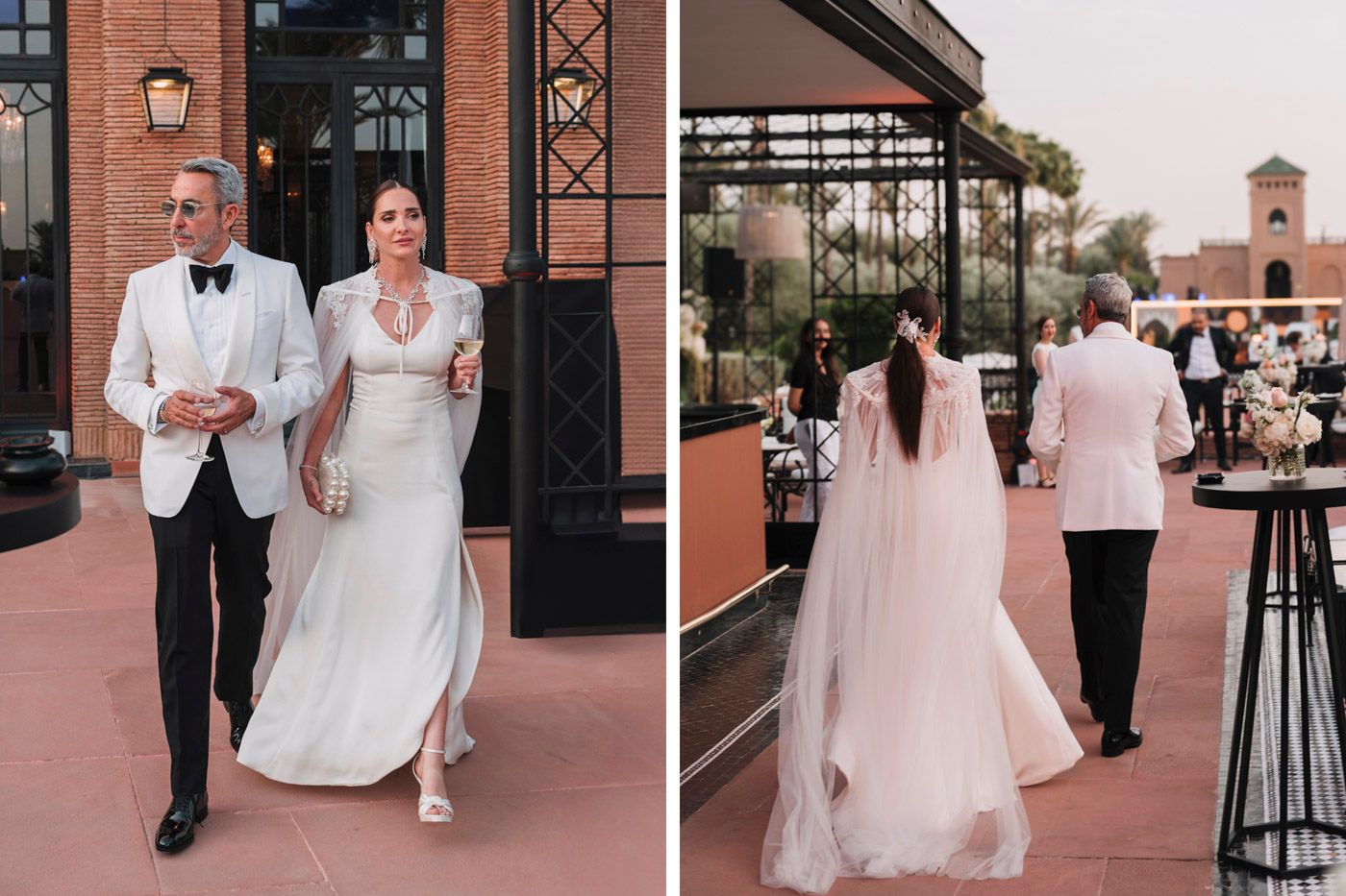 Elegant bride and groom in white walk together at a romantic outdoor venue with rustic decor and string lights.