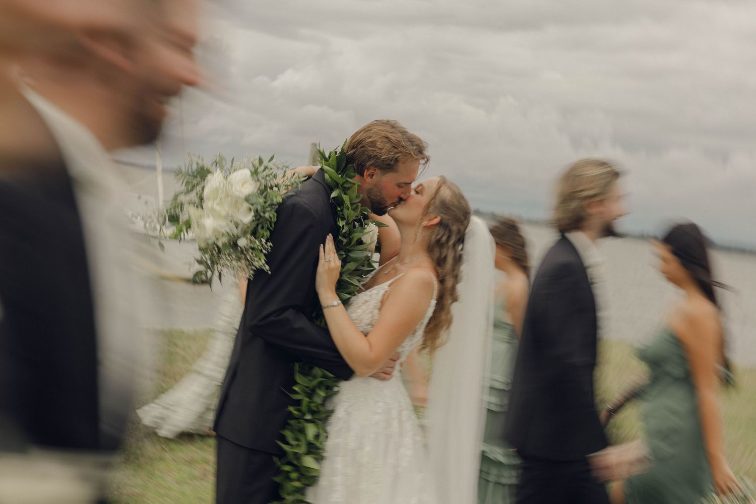A series of blurred wedding photographs showing couples dancing and embracing at an outdoor reception.