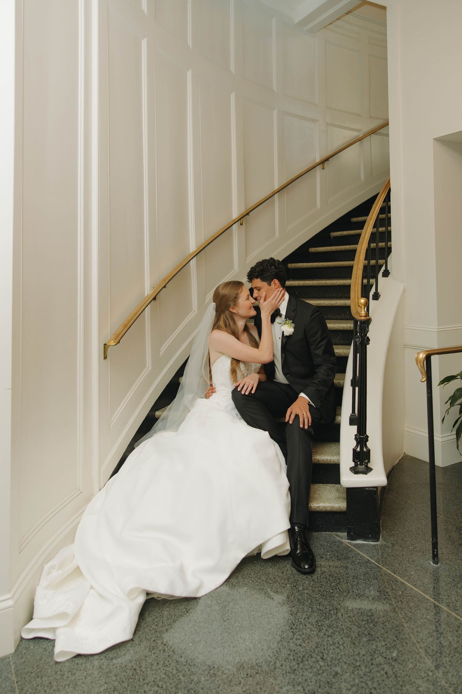 A bride and groom share a romantic moment dipping on the staircase in a sequence of wedding photos.