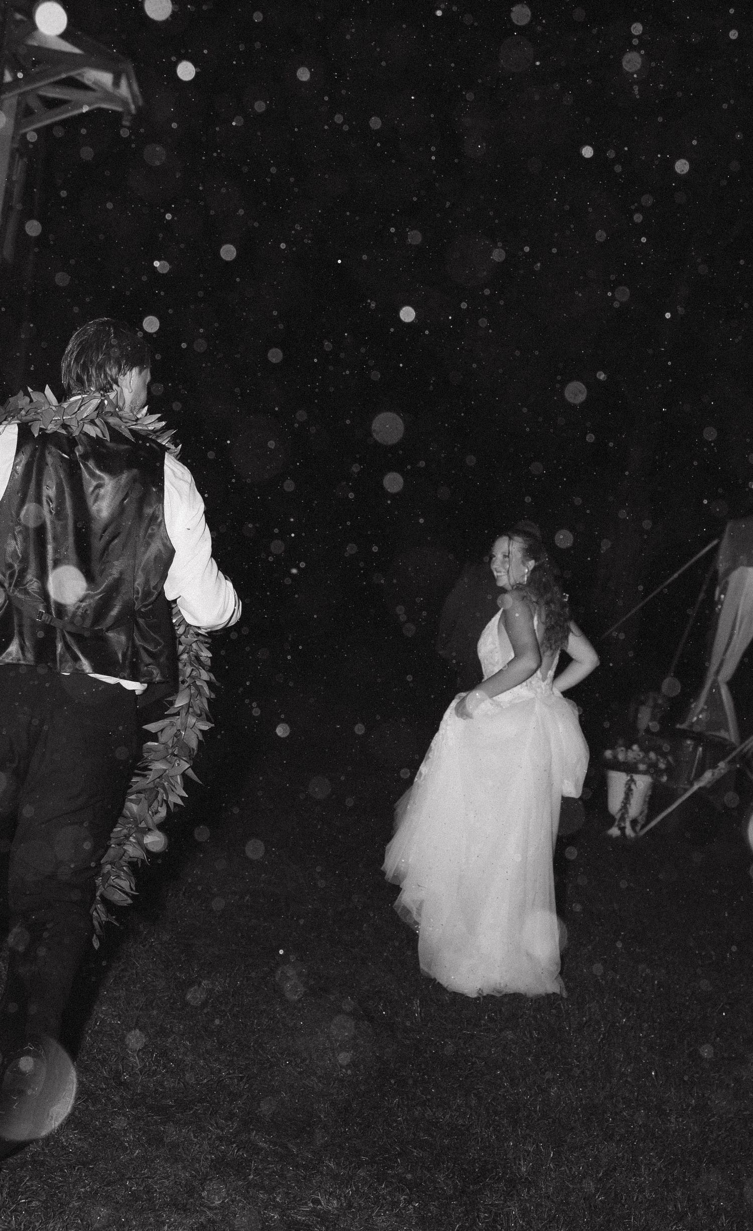 A black and white photo sequence shows a figure in a white dress dancing and twirling outdoors at night.