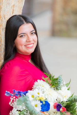 Senior girl dressed in a stunning dance outfit, surrounded by a vibrant bouquet of flowers, capturing a moment of pure beauty and grace.