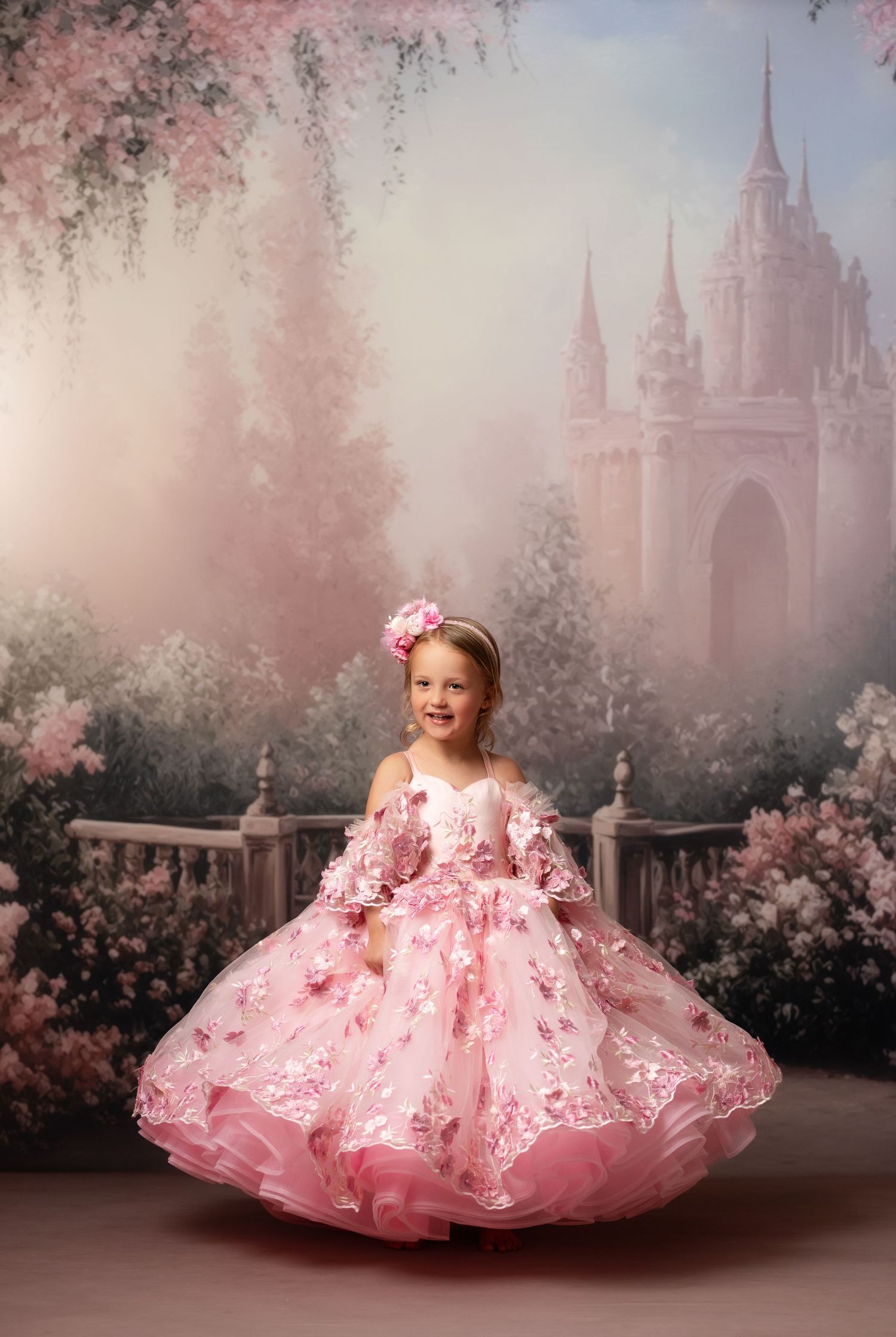 Short pink floral party dress photographed against romantic rose garden backdrop.