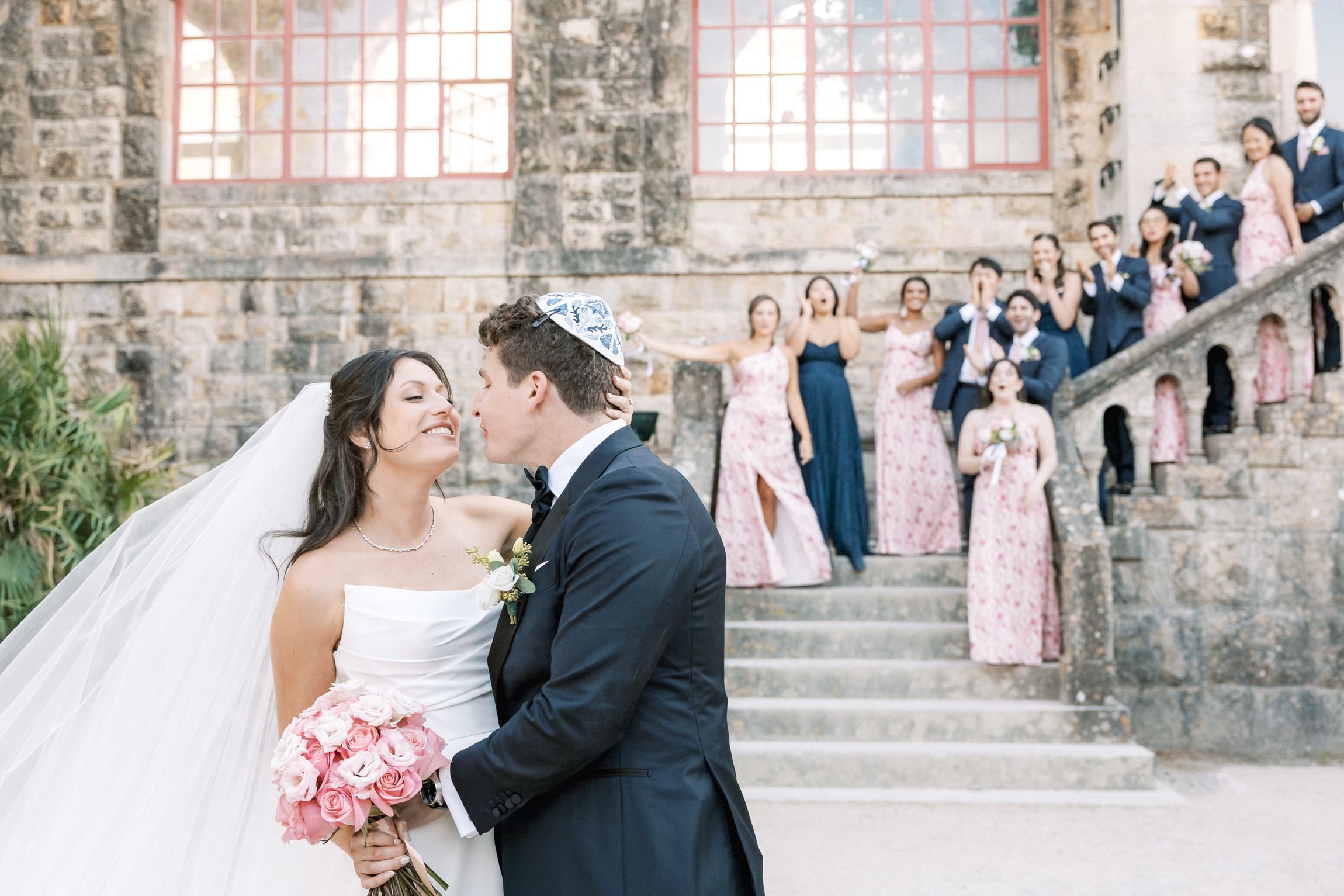 Bride and groom with bridal party in relaxed and fun wedding session in Cascais
