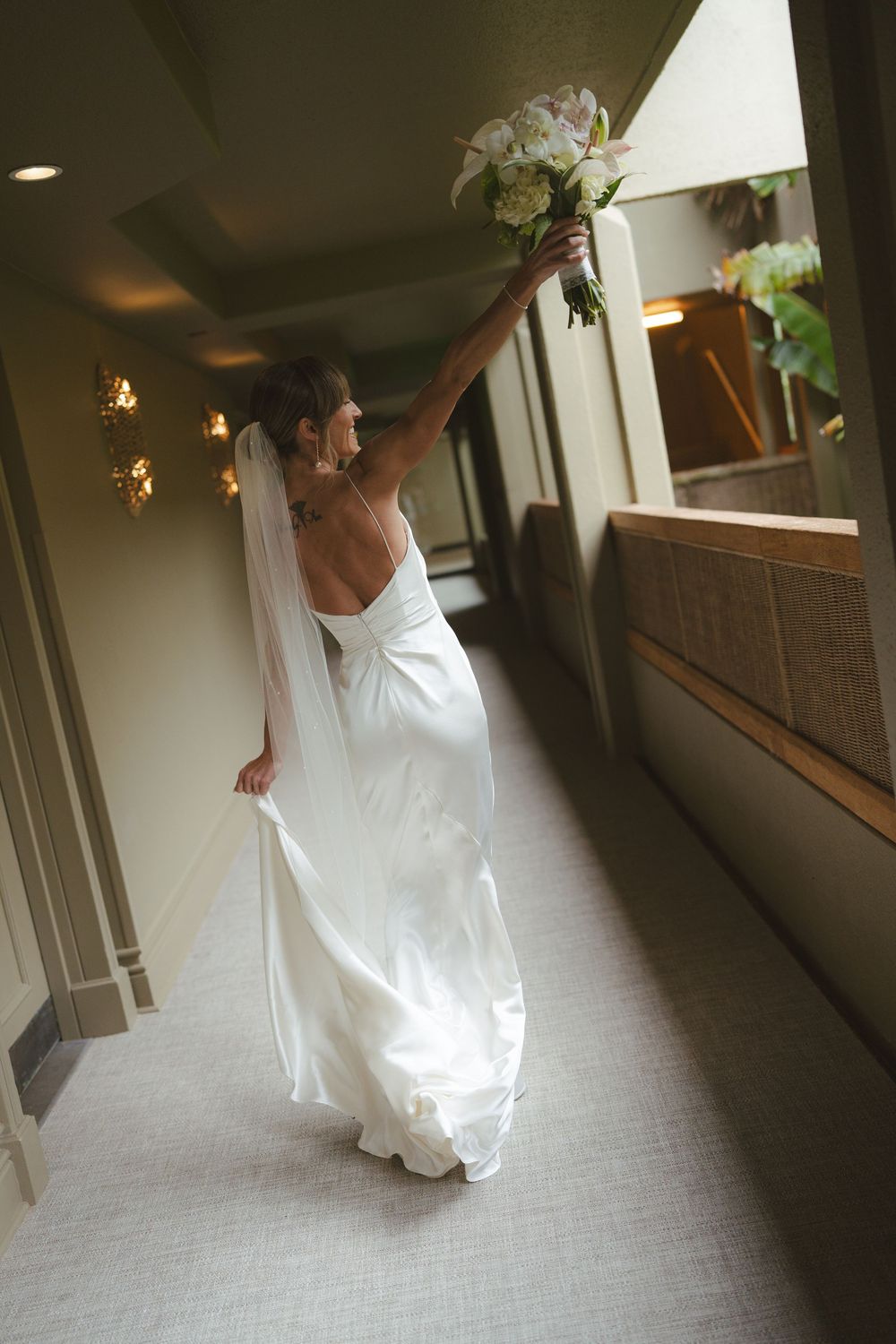 Bride walking down hall at 1 Hotel Hanalei Bay